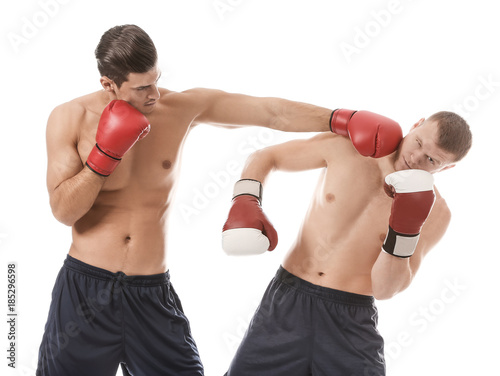 Attractive young boxers fighting on white background