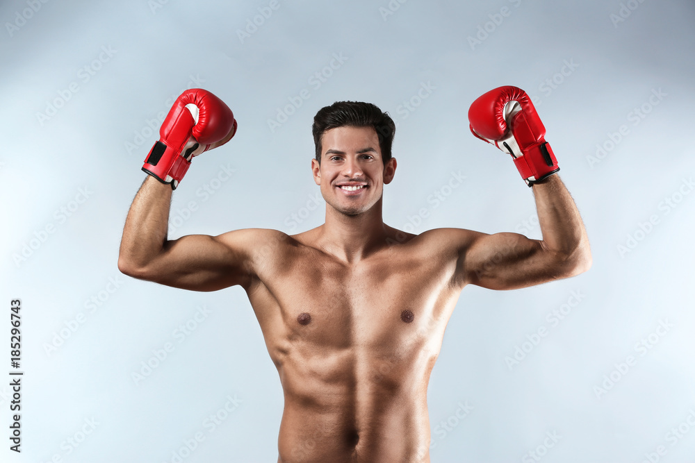 Attractive young boxer on light background Attractive young boxer on light background