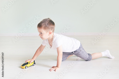 a boy playing with a car remote