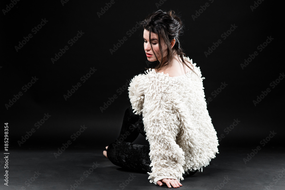 Young beautiful glamorous woman in white jacket over dark background Young beautiful glamorous woman in white jacket over dark background
