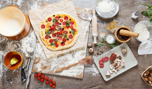 Top view cooking pizza with...