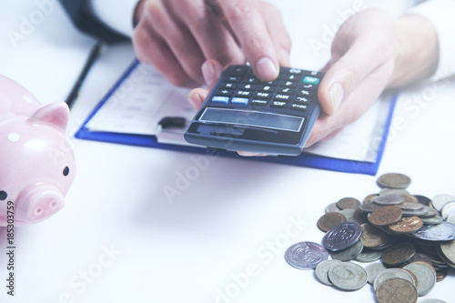 man with  calculator,money and piggy bank