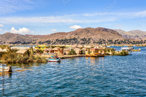Floating islands made from reeds on Lake Titicaca under blue ski