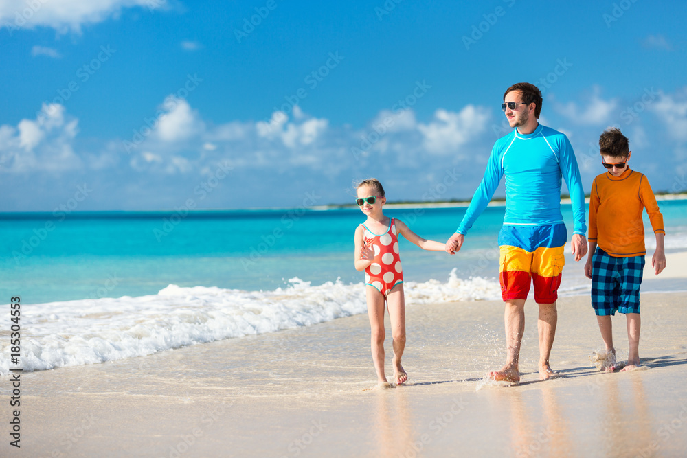 Father with kids at beach