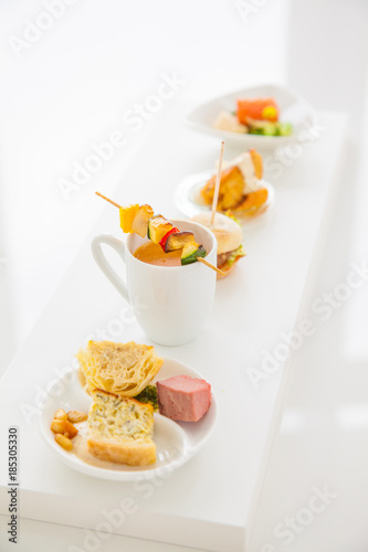 Sortiment of different appetizers ( salmon, soup, vegetable skewer,...)