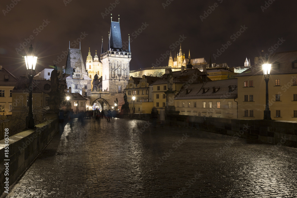 Night colorful snowy Christmas Prague Lesser Town with gothic Castle from Charles Bridge, Czech republic Night colorful snowy Christmas Prague Lesser Town with gothic Castle from Charles Bridge, Czech republic