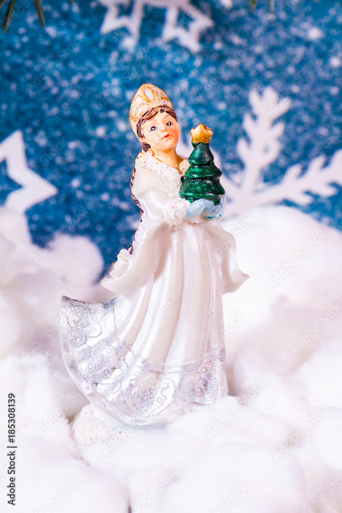 New Year's background on a background of a New Year tree Snow Maiden toy New Year's background on a background of a New Year tree Snow Maiden toy