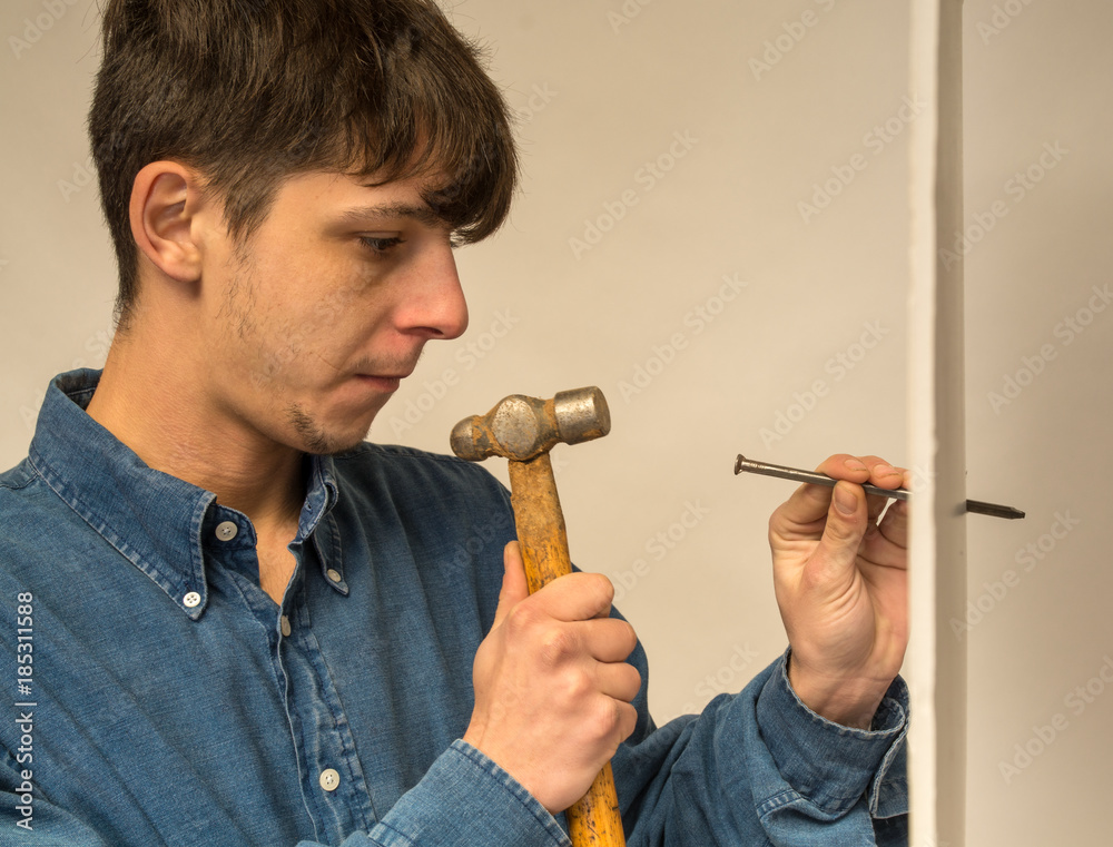 contruction worker hamming a nail contruction worker hamming a nail
