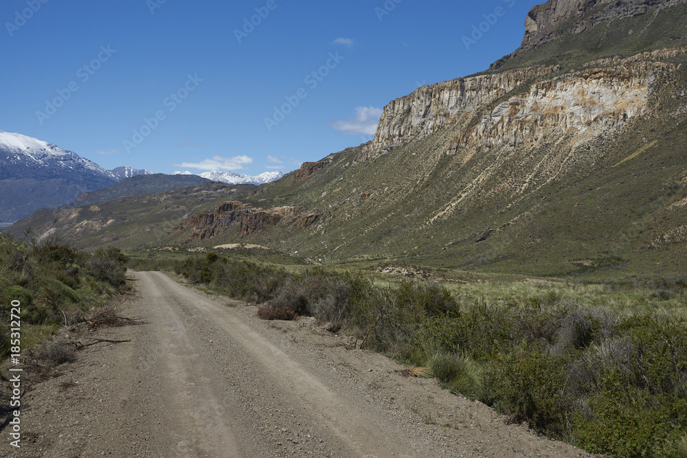 Gravel road running through the remote landscape of Valle Chacabuco in northern Patagonia, Chile