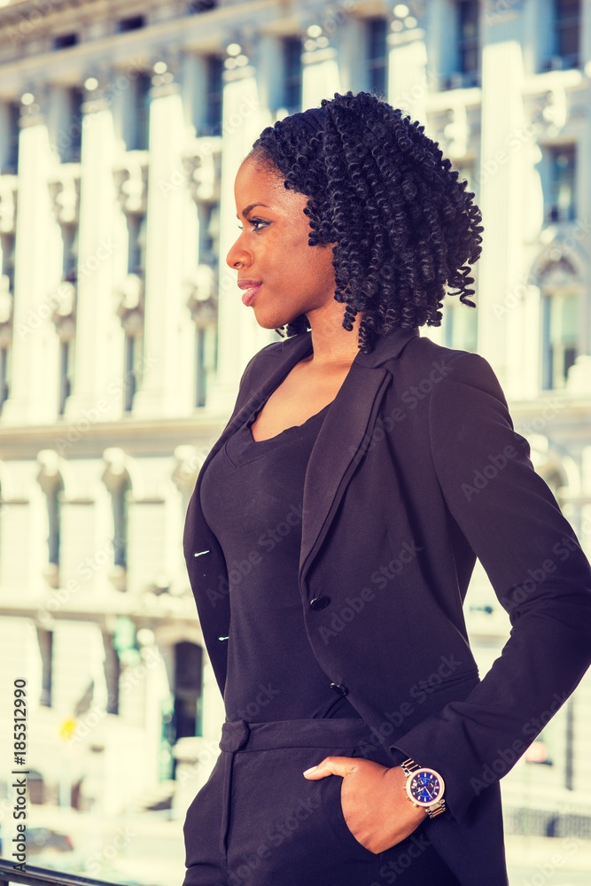 African American Business Woman working in New York. Young pretty black girl with braid hairstyle standing by vintage style office building, smiling, thinking. Side View. Filtered look.. Stock Photo | Adobe Stock African American Business Woman working in New York. Young pretty black girl with braid hairstyle standing by vintage style office building, smiling, thinking. Side View. Filtered look.. Stock Photo | Adobe Stock