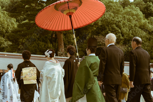 The procession of a Japanese Shinto wedding at the famous Meiji Shrine in Tokyo, Japan. The shrine is a popular site for marriage ceremonies. On busy weekends, it carries out around 15 weddings.