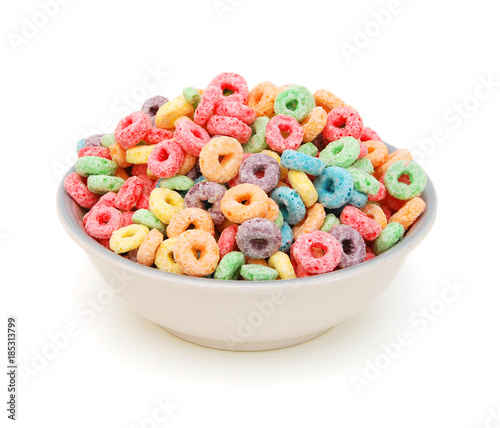 Delicious and nutritious fruit cereal loops flavorful on white background, healthy and funny addition to kids breakfast