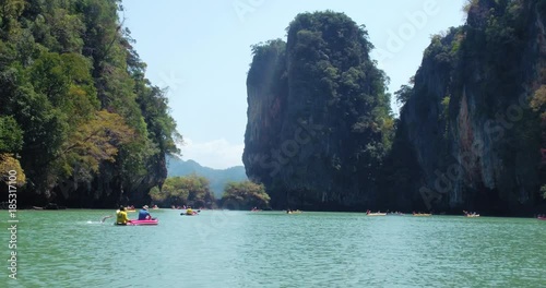 PHUKET, THAILAND, MARCH 2017:  Padling in small boats, through caves and alleys in Phi Phi Islands photo