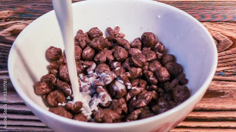 corn breakfast cereals falling in a bowl, slow motion