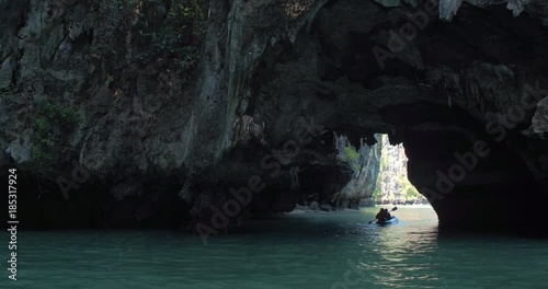 PHUKET, THAILAND, MARCH 2017:  Padling in small boats, through caves and alleys in Phi Phi Islands photo