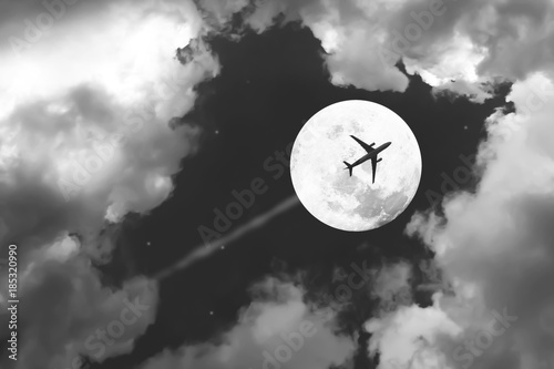 Fototapet Beautiful dramatic atmosphere of airplane in black and white night sky with jet and full moon night