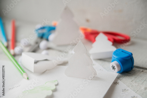 Christmas table with various items. Woman's hands putting a letter in an envelope