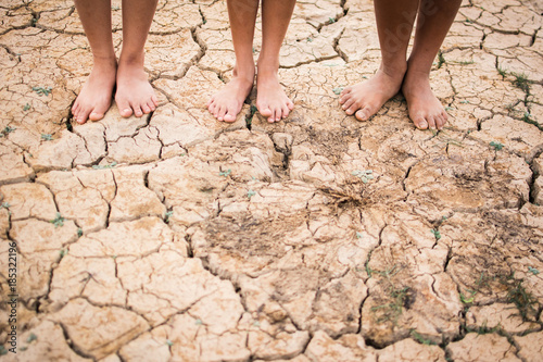 Feet people on cracked dry ground .concept hope and drought