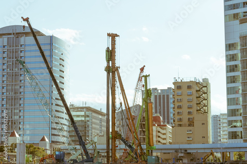 A construction site next to newly constructed buildings in Tokyo, Japan