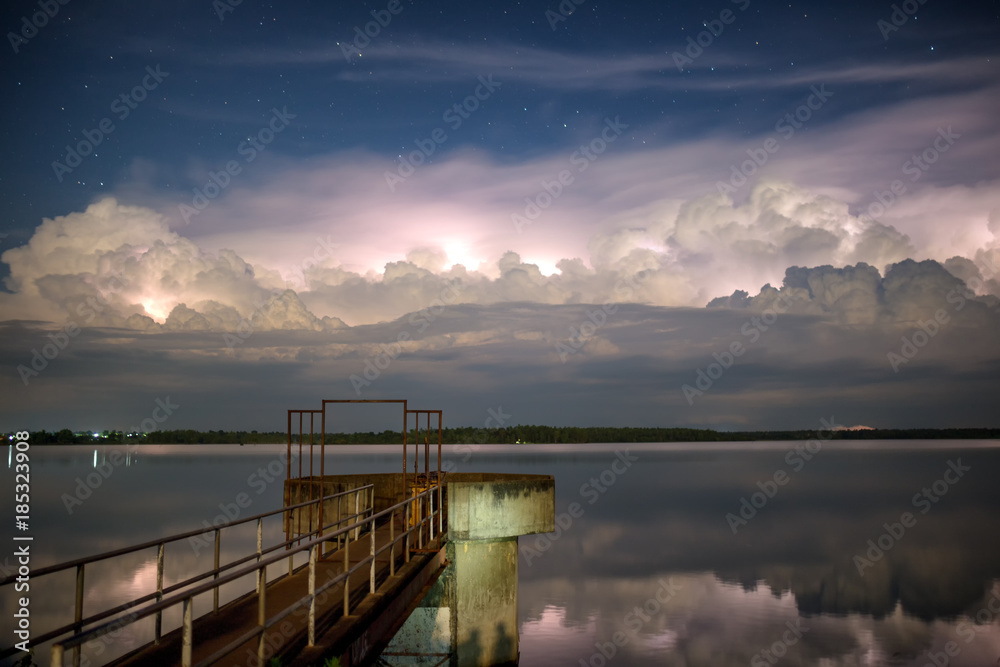 The bridge extends into the lake. And clouds, rainstorms and stars.