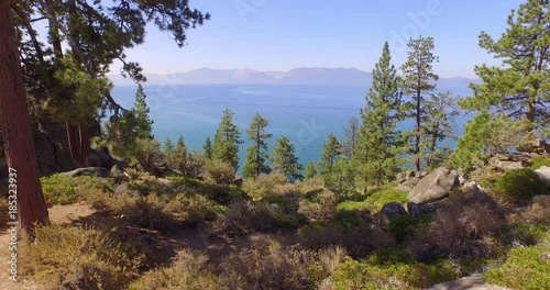 Scenic aerial flight toward beautiful Lake Tahoe panorama in Nevada. 4K UHD.