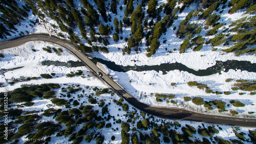 aerial view of a road over a snowy river. 