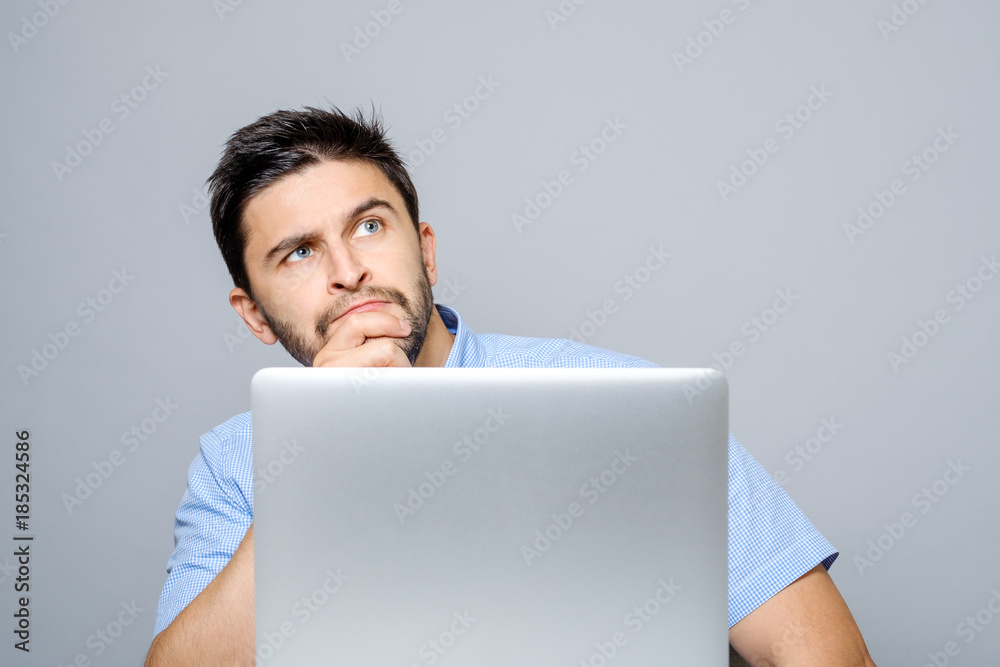 Portrait of serious concentrated man working at laptop Portrait of serious concentrated man working at laptop