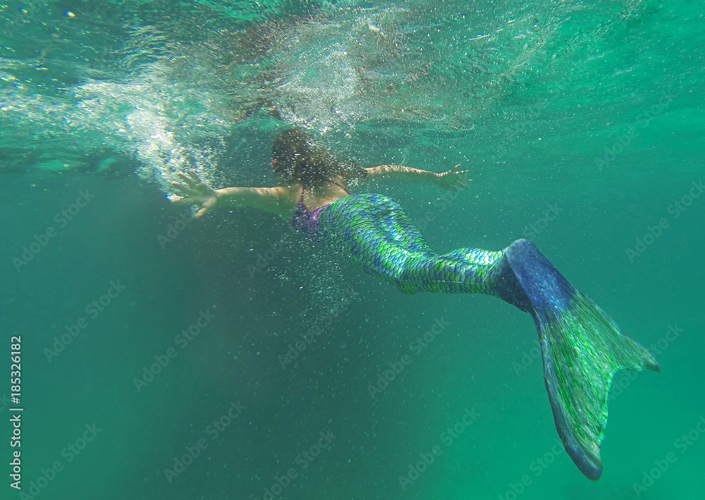 Mermaid in the sea, beautiful blond woman with fish mermaid tail swimming underwater in the blue green ocean water, beauty and nature, awesome people, creative picture