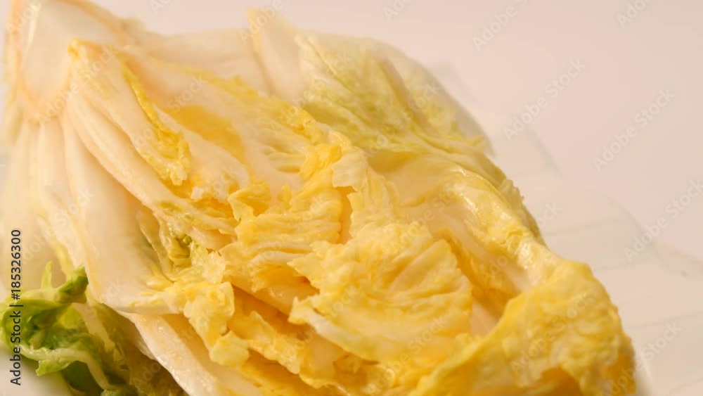 Rotate salt pickled cabbage for kimchi on a dish. Rotate salt pickled cabbage for kimchi on a dish.