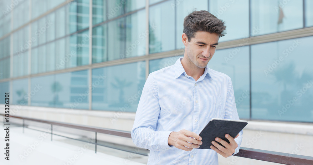 Caucasian Man use of tablet computer at outdoor Caucasian Man use of tablet computer at outdoor