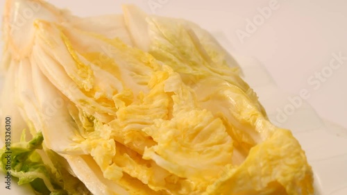 Rotate salt pickled cabbage for kimchi on a dish.