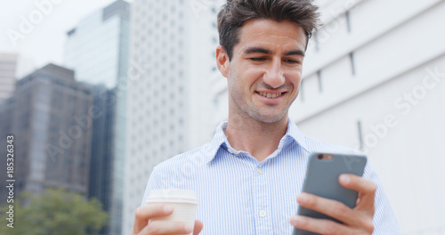 Photography Caucasian man use of cellphone in city