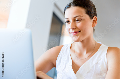 Young beautiful woman working on her laptop Free Download Young beautiful woman working on her laptop - GFXLoad