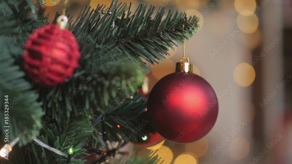 close-up macro shot of a happy baby hand hanging ball on a Christmas tree, children decorating a Christmas tree. close-up macro shot of a happy baby hand hanging ball on a Christmas tree, children decorating a Christmas tree.