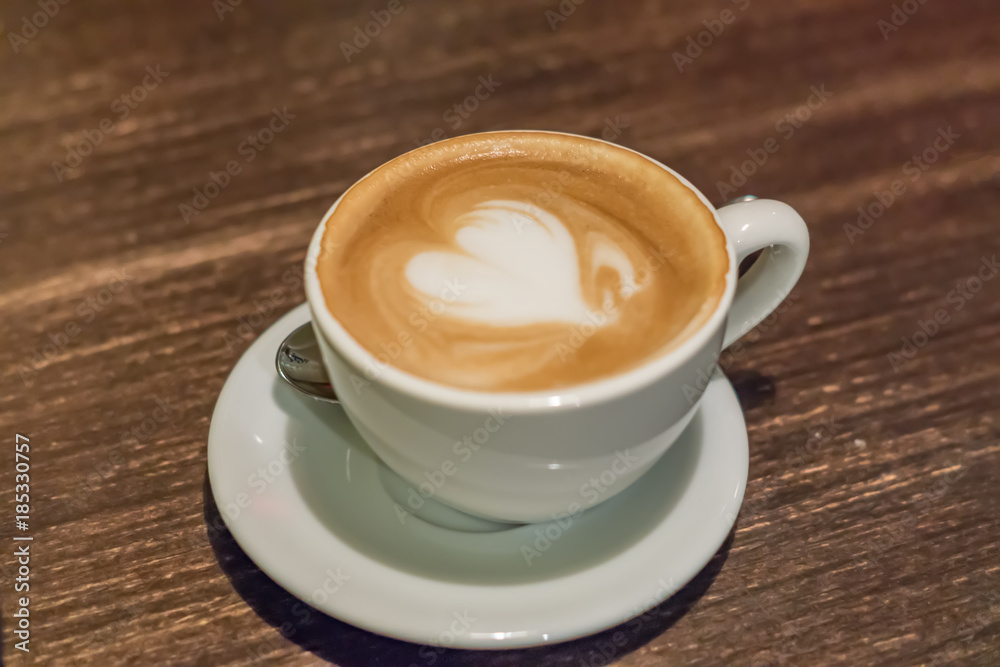 cup of cappuccino with heart on wooden table closeup cup of cappuccino with heart on wooden table closeup
