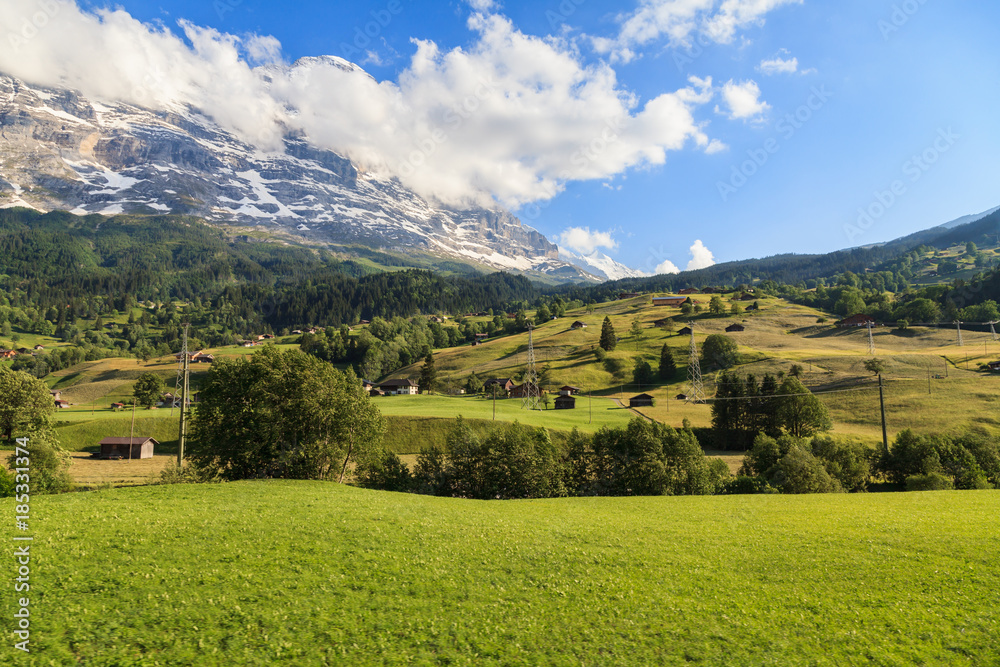 Beautiful summer view of mountain and small village. Beautiful outdoor natural scene in Swiss Alps, Switzerland, Europe.