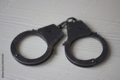 Handcuffs on a wooden table