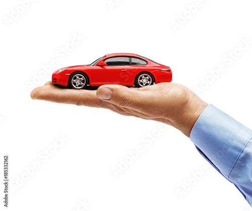 Man's hand in shirt holding new red car isolated on white background. Close up. High resolution product