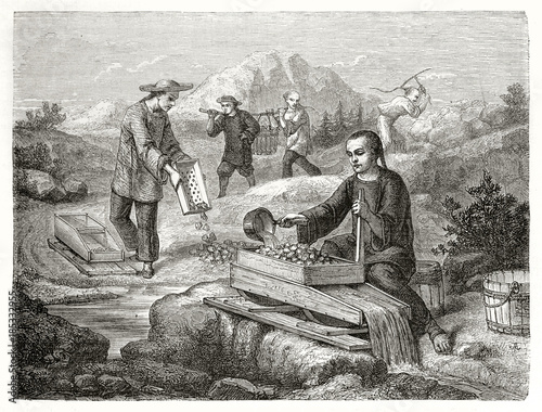 Ancient chinese miners sifting and washing gold-bearing sand, outdoor in California. Created by Chassevent after previous engraving by unknown author published on Le Tour du Monde Paris 1862 photo