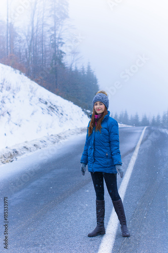 Woman walk and rest in snowy mountains forest, alpine view, snow on hills. Winter magical time for good vacation.  