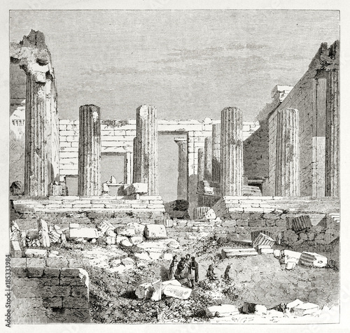 Ancient majestic greek ruins and columns standing next to few small people. Old view of Propylaea in the Athenian Acropolis. Created by Therond published on Le Tour du Monde Paris 1862 photo