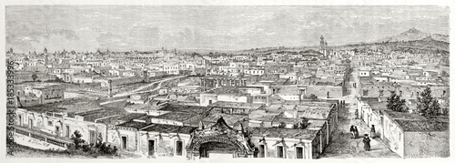 Old panoramic view of eastern side of Puebla Mexico with its typical white low houses and little hills in the distance. By Catenacci after photo of Charnay published on Le Tour du Monde Paris 1862