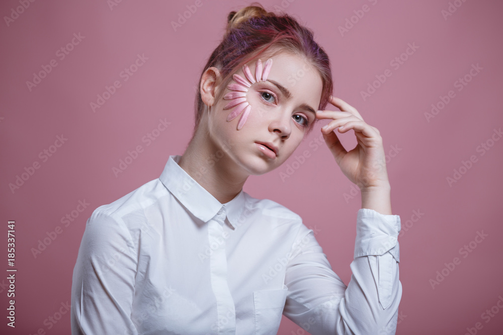 Portrait of beautiful young woman looking at camera with a flower. Close up face of beauty girl with flower gerbera on pink background. Skin care and beauty concept. Portrait of beautiful young woman looking at camera with a flower. Close up face of beauty girl with flower gerbera on pink background. Skin care and beauty concept.