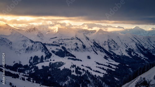 Early morning at the Chlushuette in the Swiss Alps. Sunrise over the Eiger, Jungfrau and Mönch mountain area. Sun breaking through after a heavy snow storm on a winter day in just before Christmas © Dennis Wegewijs