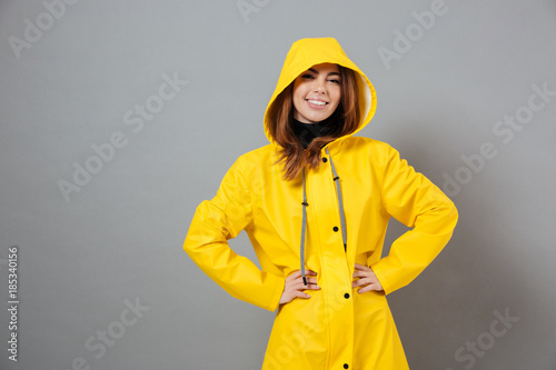 Portrait of a cheerful girl dressed in raincoat posing