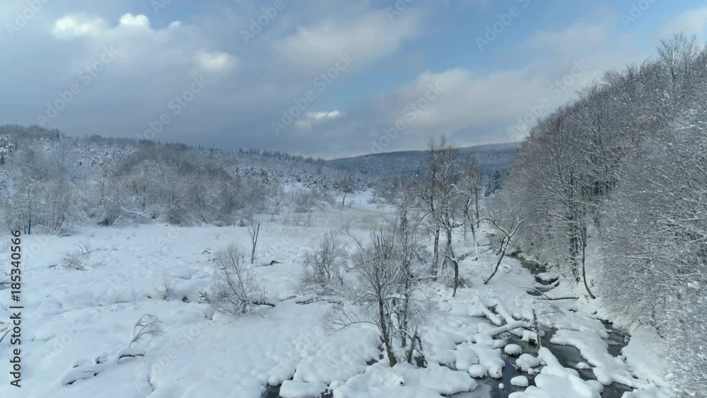 Aerial shot along the river among the Carpathian Mountains in winter 4K Aerial shot along the river among the Carpathian Mountains in winter 4K