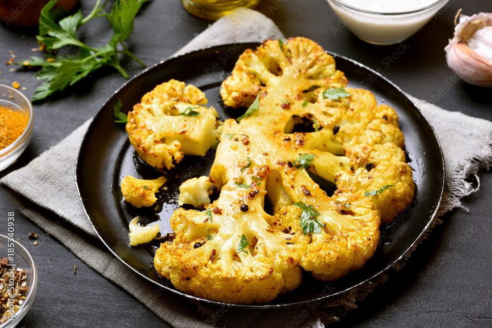 Tasty cooked cauliflower steak with herbs and spices Tasty cooked cauliflower steak with herbs and spices