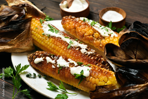 Grilled corn with greens and sauce