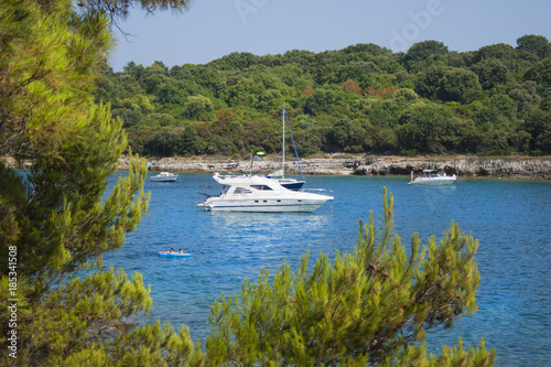 Pula, Croatia. Yacht in a bay against a background of green trees