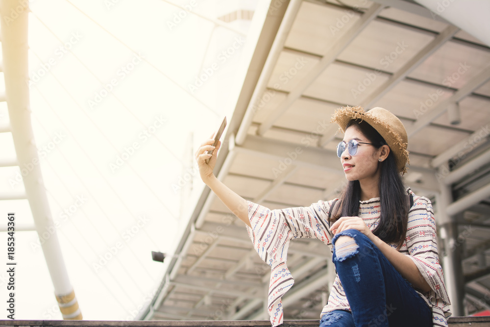 Asian woman tourist using smartphone selfie during travel in Bangkok, Relax time on vacation hipster life